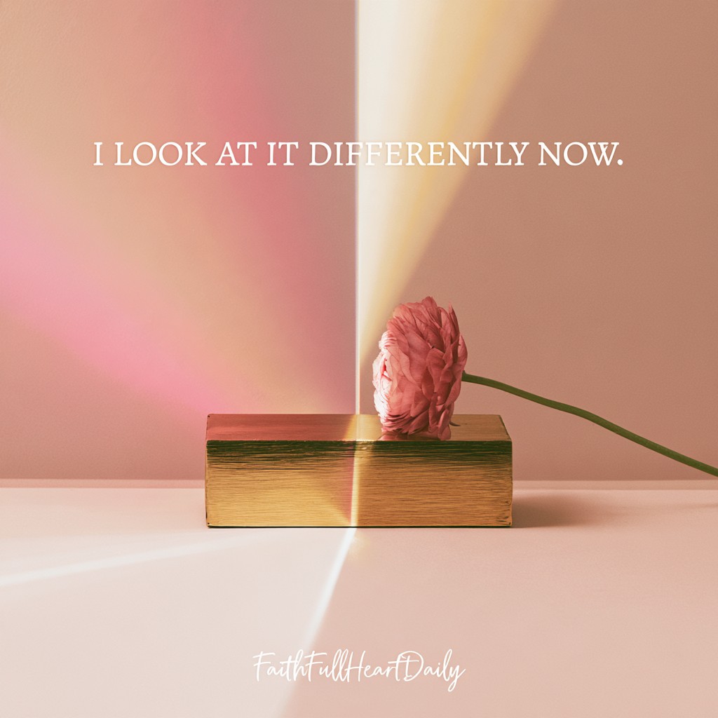 An aesthetic editorial graphic titled 'I LOOK AT IT DIFFERENTLY NOW.' featuring an antique brass object, pink flower, and prism light beam by FaithFullHeartDaily.